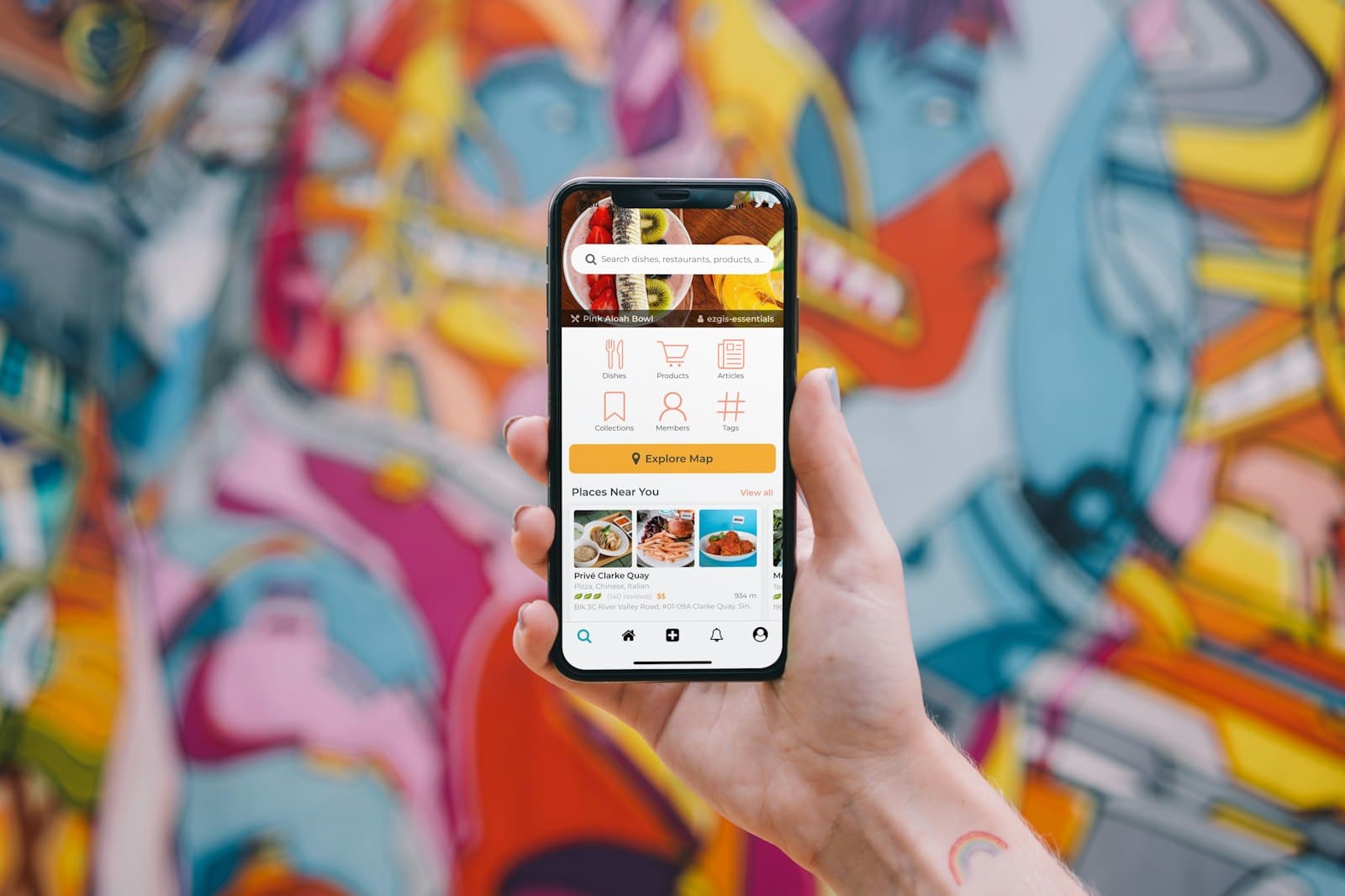 Hand holding a phone showing a food ordering app