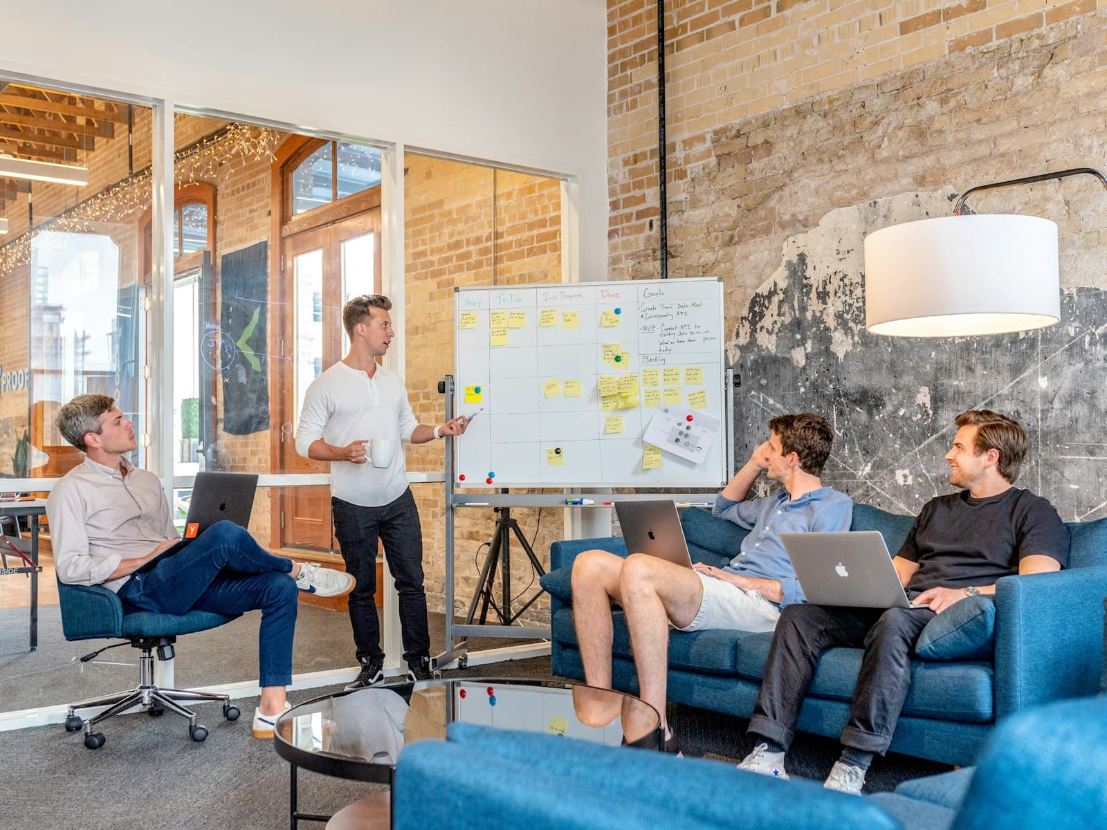 Team discussion around a whiteboard in a loft office