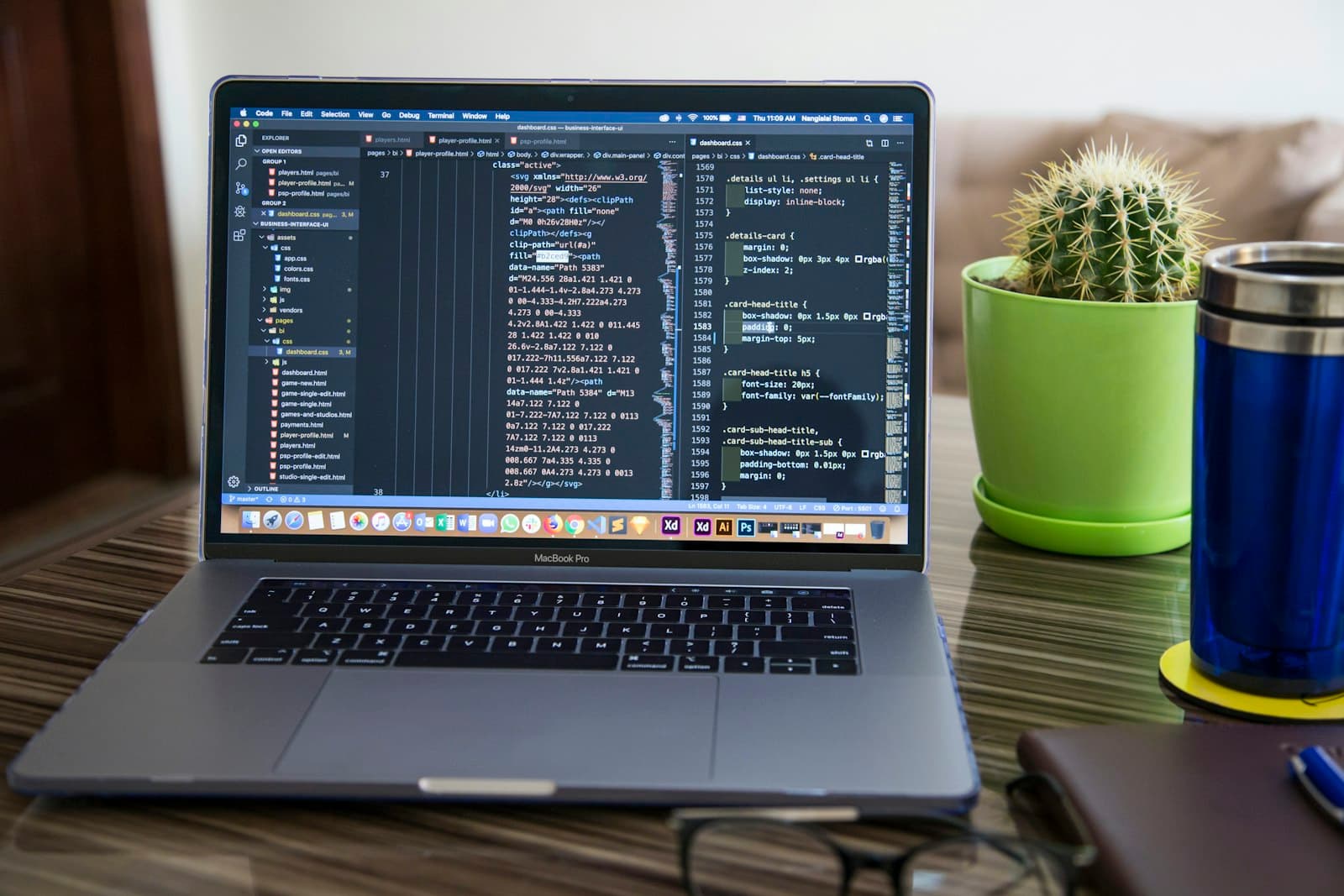 Laptop showing code on a tidy desk